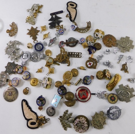 Various army cap badges, etc., a Ubique cannon cap badge, 4cm high, RAF, and various others, iron on wings, etc. (a quantity)