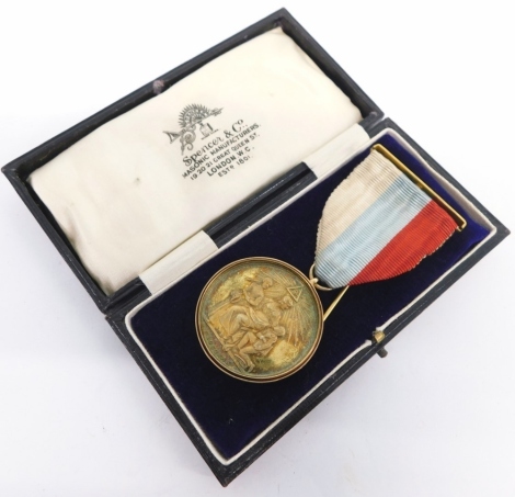 A 15ct gold edged Masonic jewel, marked Honorable Testimony Masonic Charity and Benevolence Instituted by HRH Aug Fred Duke of Sussex MW Grand Master, with ribbon, 9cm high, 34g all in, in Spencer and Co. London case.