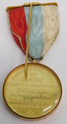 A 15ct gold edged Masonic jewel, marked Honorable Testimony Masonic Charity and Benevolence Instituted by HRH Aug Fred Duke of Sussex MW Grand Master, with ribbon, 9cm high, 34g all in, in Spencer and Co. London case. - 2