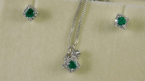 An 18ct white gold emerald and diamond necklace and earring set, with square studs with central emerald, surrounded by tiny diamonds, the pendant same form set as a diamond shape, on curb link neck chain, 52cm long, white metal stamped 750, 7.5g all in, b