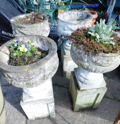 Four similar garden planters, of classical form, each on removable plinth bases.