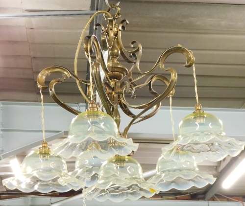 A brass Art Nouveau design five branch chandelier, set with six vaseline glass shades, on an entwined baluster column, 47cm high.