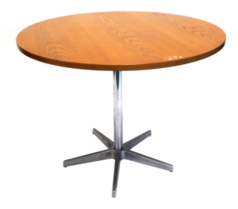 A vintage light oak circular top dining table, on a chrome stem terminating in spoke feet, 75cm high, 101cm diameter.