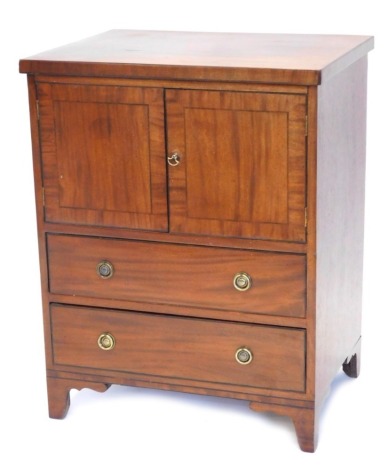 An early 20thC mahogany commode, with cupboard front above two drawers on ogee bracket feet, 81cm high, 63cm wide, 48cm deep.