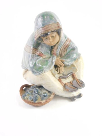 A 20thC Lladro figure of a child, EL64 impressed and printed marks beneath, 14cm high.