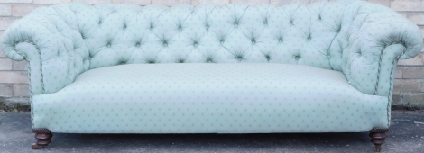 A Victorian Chesterfield sofa, with green patterned upholstery, and turned walnut legs, 200cm wide.