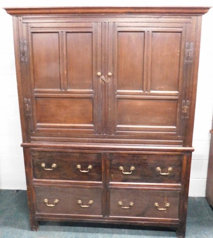 An early 18thC oak cupboard, with moulded cornice, fielded panelled doors to the upper part, and an arrangement of four drawers with brass swan neck handles to base, 198cm high, 153cm wide, 56cm deep.