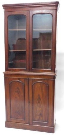 A Victorian mahogany bookcase, with moulded cornice, two glazed doors over two panelled doors and plinth base, 213cm high, 93cm wide, 40cm deep.