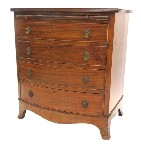 An early 19thC mahogany bow front bachelor's chest, with reeded top, brushing slide, and four graduated drawers with brass loop handles, and splay feet, 70cm wide.