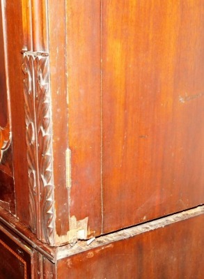 A George III mahogany linen press, with moulded cornice, two shaped and satinwood cross banded doors over four chequer banded drawers, with cast loop handles, on gadrooned and turned feet, 217cm high, 150cm wide. - 2