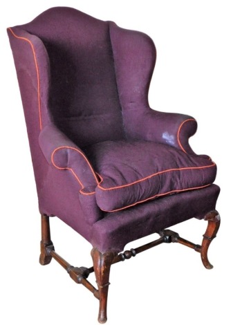 A 19thC wing armchair, with mahogany stepped cabriole legs and turned H frame stretcher, 82cm wide over arms.