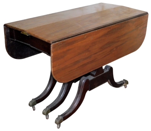 A 19thC mahogany extending Pembroke table, with fall flaps, and six sabre legs with brass paw caps, on castors, 74cm high, 106cm wide, 53cm deep.