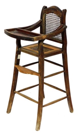 A Victorian child's highchair, with caned back and seat.