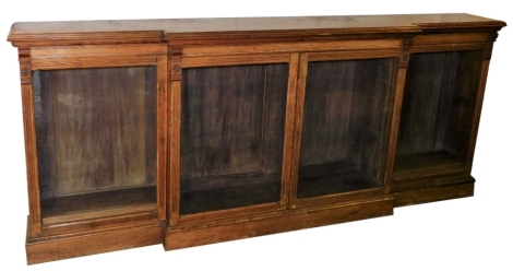 A Victorian light oak breakfront bookcase, with moulded cornice, and four glazed doors, on a plinth base, 116cm high, 277cm wide, 40cm deep.