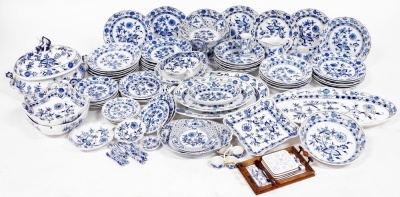 An early 20thC Meissen Onion pattern blue and white porcelain dinner and dessert service, comprising soup tureen and cover, with figural finial, pair of graduated meat platters, oval fish platter, integral sauce boat on stand, three square dishes, twenty-