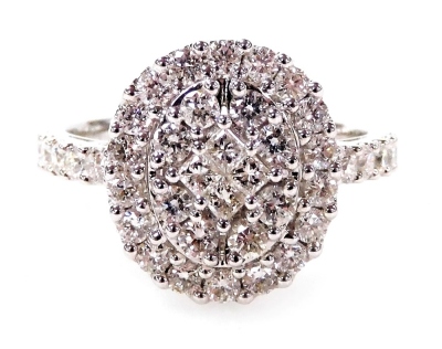 A 18ct white gold diamond cluster ring, set with an arrangement of round brilliant and square cut diamonds with two layer ring head and five round brilliant cut diamond shoulders, each in claw setting totalling approximately 1.16ct, ring size M, 4.3g all