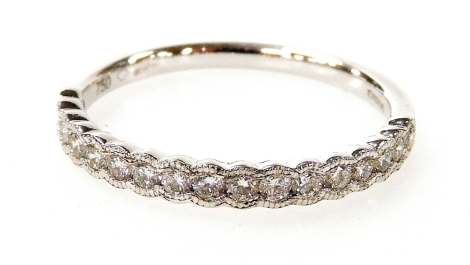 An 18ct gold white gold and diamond half hoop eternity ring, set with seventeen round brilliant cut diamonds totalling approximately 0.37ct, ring size N, 1.8g all in.