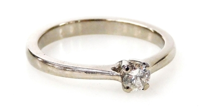 A palladium and diamond solitaire ring, with a round brilliant cut diamond totalling 0.19ct, in a four claw setting, ring size N½, 2.8g all in.