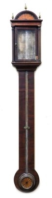 A George III stick barometer by Manticha of London, in an inlaid mahogany case with architectural arched hood, enclosed by a single glazed door within pillars, the plain longcase with boxwood stringing, and circular roundel paterae to the terminal, calibr