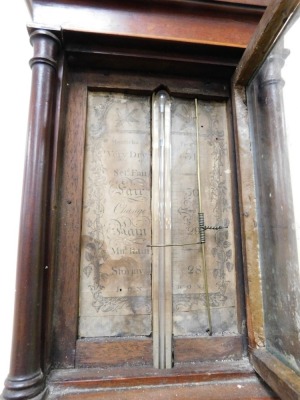 A George III stick barometer by Manticha of London, in an inlaid mahogany case with architectural arched hood, enclosed by a single glazed door within pillars, the plain longcase with boxwood stringing, and circular roundel paterae to the terminal, calibr - 2