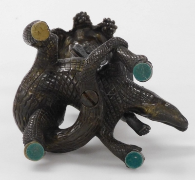 An early 20thC bronze Bacchanalian figural candlestick, in the form of a Bacchanalian cherub seated on a crocodile supporting a fruiting vine sconce, 19cm high. - 3