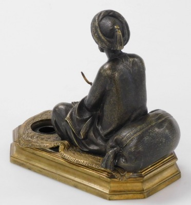 A 19thC bronze patinated figure of a Middle Eastern gentleman, seated on a carpet, incorporating a small ink receiver and mounted on a formal octagonal brass plinth, 14cm high. - 2