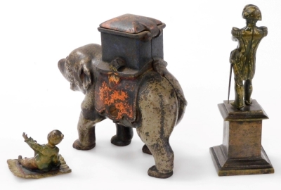 A small 19thC bronze statue of Napoleon, in a standing pose with folded arms, on a square plinth, together with a small cast bronze patinated and painted figure of an Oriental child on a rug, and a cast iron model of an elephant, trunk lacking. (3) - 2