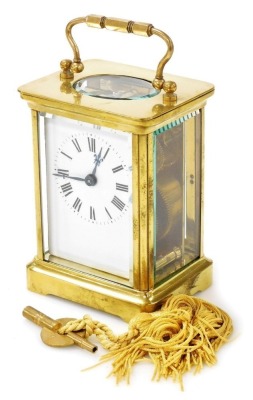 A brass cased carriage clock, with white enamel dial and Roman numerals, within a plain brass case, the movement with fast/slow regulator, 11.5cm high, with key.