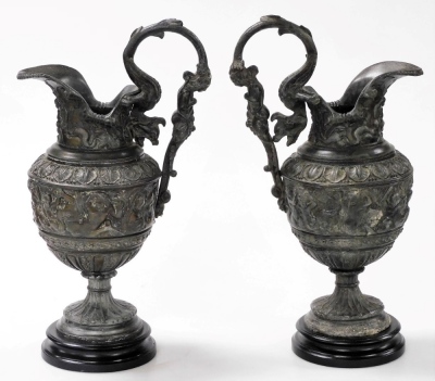 A pair of late 19thC white metal Cellini ewers, in the Renaissance style, with figural handles and lappet borders above a band of classical figures, raised on turned ebonised socles, 44cm high. - 3