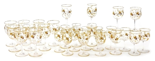 A suite of early 20thC French table glass, with tulip shaped bowls decorated sprays of rosebuds in gilt, and comprising nine small wine glasses, twelve dessert wine or sherry glasses, and six port wine glasses. (27)