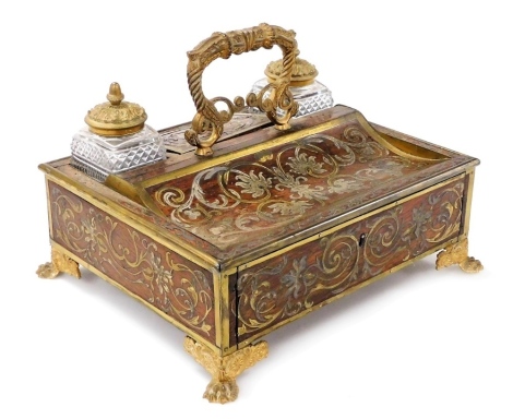 A 19thC rosewood brass and silvered metal Boulle marquetry inkstand, with gilt metal mounts, the top insert with two cut glass inkwells, flanked by a lidded cover, the base with a single drawer on paw feet, 30cm wide.