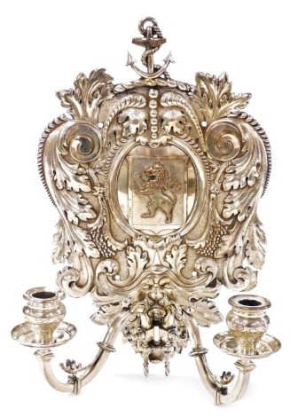 A Victorian Elkington electrotype silver plated wall sconce, the shield shaped back decorated with an anchor and heraldic lion, mounted with two candle arms, with sconces, 39cm high, 26cm wide.