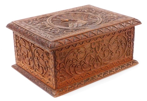 A late 19th/early 20thC carved Indian hardwood box, the lid decorated with a peacock, 27cm wide.