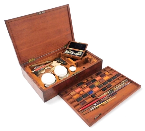 A 19thC mahogany artist's paint box, the hinged lid enclosing divisions for watercolour paints, mixing vessels, etc., containing some fittings, stamped Windsor and Newton, etc., 38cm wide.