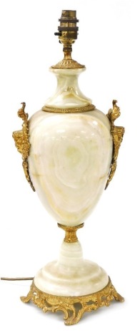 A Continental green onyx and gilt metal table lamp, applied with rococo scroll masks, etc., on a pierced base, 49cm high.