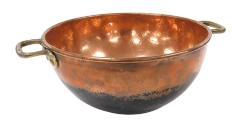 A late 19th/early 20thC hammered copper and brass mixing bowl, 62cm wide.