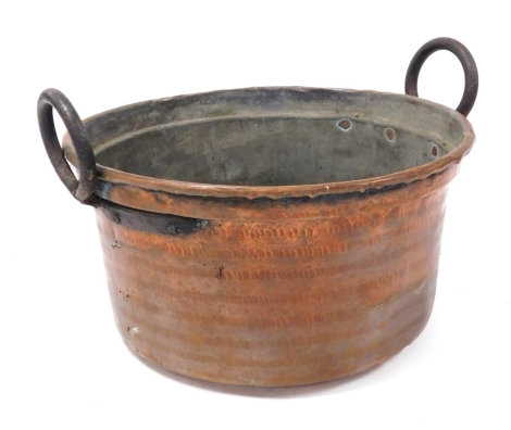 A Continental brass and iron two handled bowl, with hammered decoration, 45cm wide.