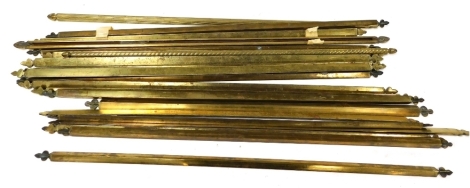 A collection of brass stair rods, each with a shaped end, 74cm wide, etc.