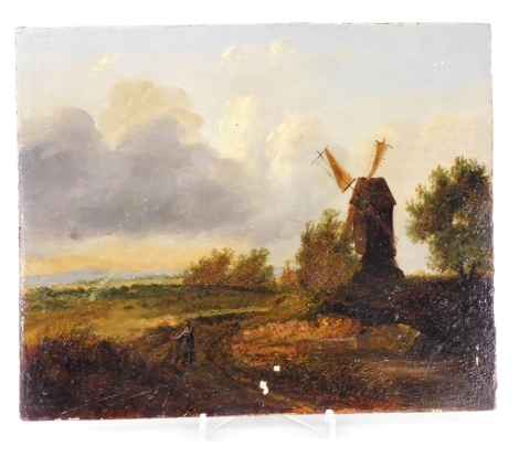 19thC English School. Rural landscape with a windmill and a figure in the foreground, oil on wooden panel, bears paper label verso with indistinct handwritten script, 20.5cm x 25cm.