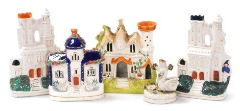 Two Victorian Staffordshire pottery cottages, and two Victorian Staffordshire architectural spill vases, and a swan quill holder and ink receiver, in various sizes. (5)