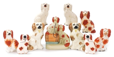 Victorian and later Staffordshire comforter dogs, comprising four pairs of King Charles Spaniels, one off King Charles Spaniel, and a later Spaniel group with barrel, in varying sizes. (10)