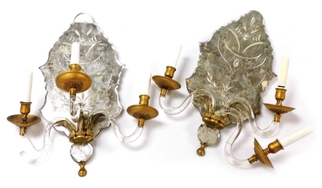 A pair of Venetian style three branch girandoles, with shaped mirror backs and plain glass scrolling branches supported by acanthus leaves, 55cm high.