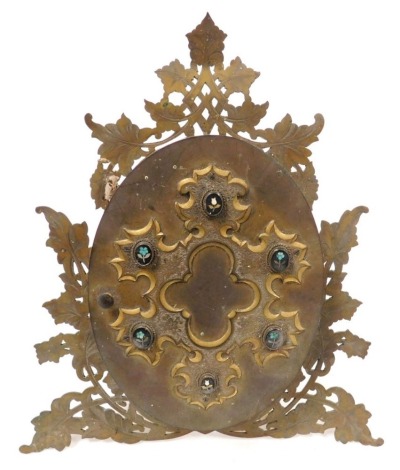 A Victorian brass oval double folding photograph frame, the hinged cover with blind fret style raised scroll decoration, set with six small oval micro mosaic jewels, and opening to reveal two further oval photograph frames (2 glazed), within a pierced and