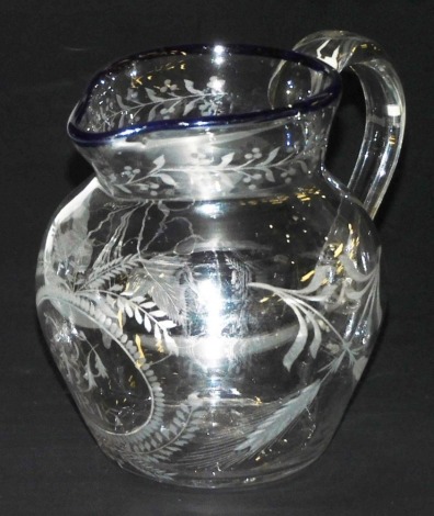 A Regency cut glass water jug, with a blue glass rim, central circular reserve monogram engraved and dated 1815, flanked by barley and vines, 15cm high.