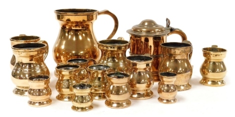 A group of 19thC brass beer flagons, measures, and a lidded tankard. (a quantity)