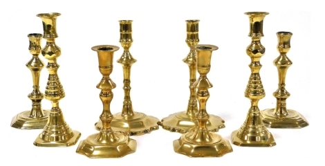 Four pairs of Georgian and later brass candlesticks, 18-23cm high.