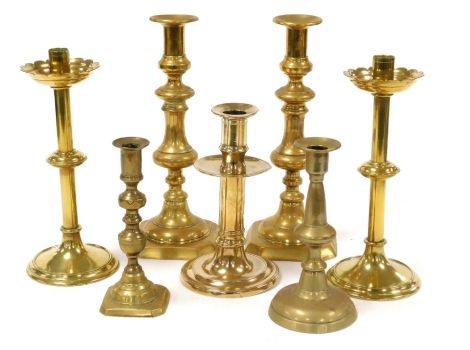 A group of Georgian and later brass candlesticks, comprising two pairs, 30cm and 25cm high, and three single candlesticks. (7)