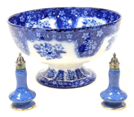 A pair of early 20thC Royal Doulton pottery powder blue ground pepper and salts, with plated mounts, made exclusively for Mignon, printed marks, 12.5cm high, together with a Royal Doulton blue and white pottery fruit bowl, decorated internally with a bask