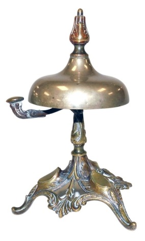 A Victorian brass and silver plated counter bell, raised on a foliate scroll base, bears registration mark, 16cm high.