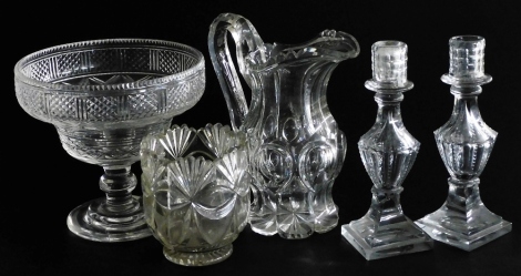 A group of Victorian cut glassware, comprising a pair of candlesticks, water jug, pedestal fruit bowl, and a vase. (5)